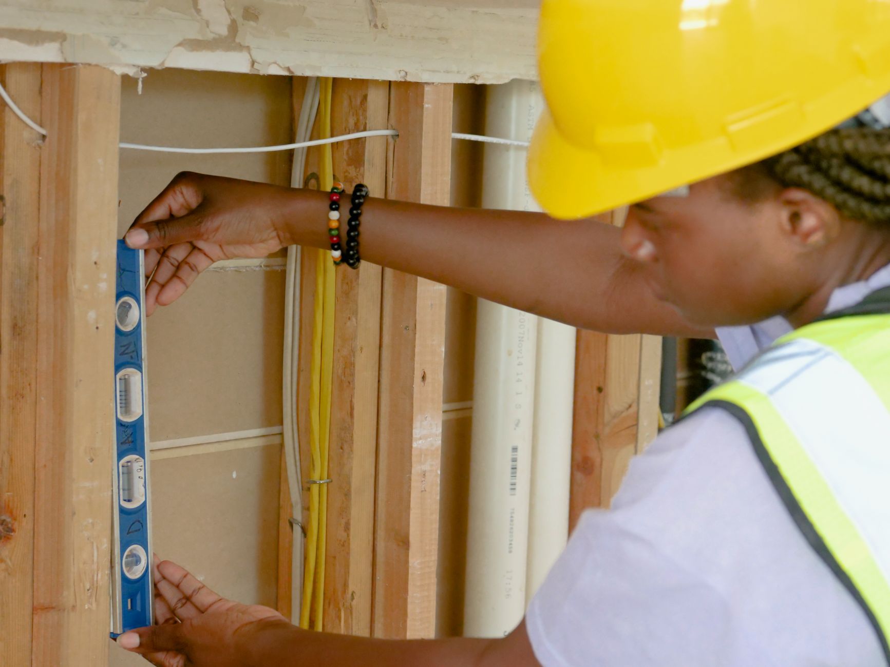 Glazier measuring an aluminium frame on site